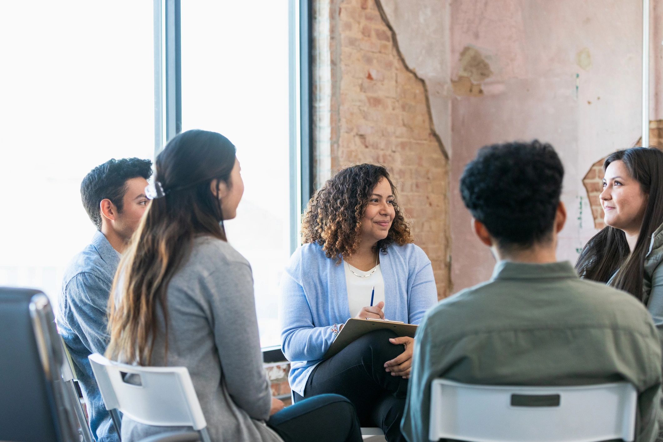 Support group listening attentively as someone shares